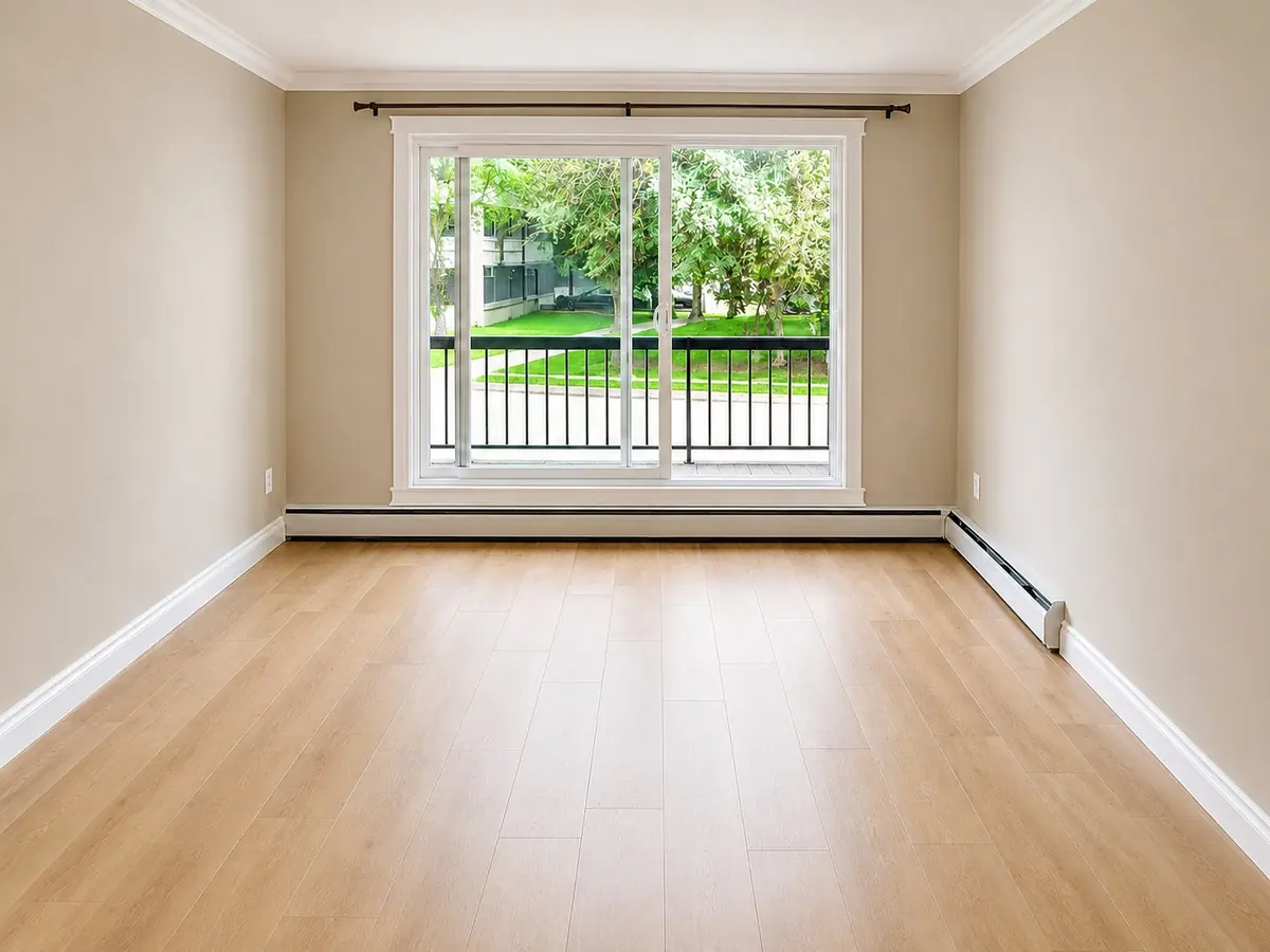 Managed residential apartment interior with large window and new flooring completed by 780 Construction